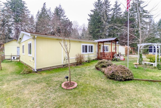 view of front of property with a pergola, a deck, and a front yard