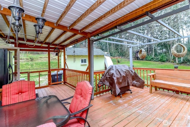 deck featuring a grill and a yard