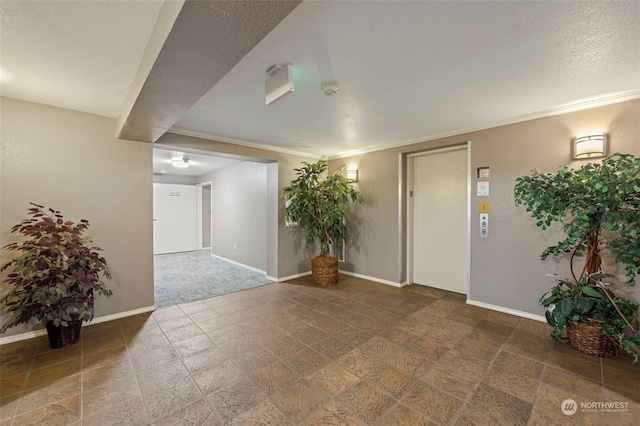 interior space with crown molding, a textured ceiling, and elevator