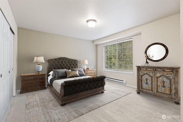 carpeted bedroom with a baseboard radiator, a textured ceiling, and a closet