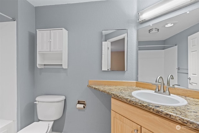 full bathroom featuring shower / bath combination, vanity, and toilet