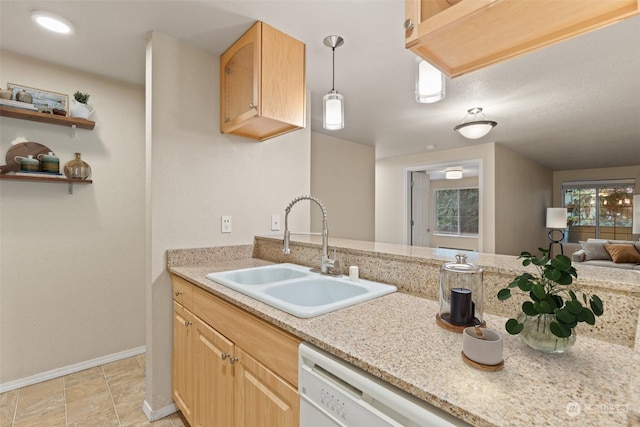 kitchen with light brown cabinetry, decorative light fixtures, dishwasher, sink, and light stone counters