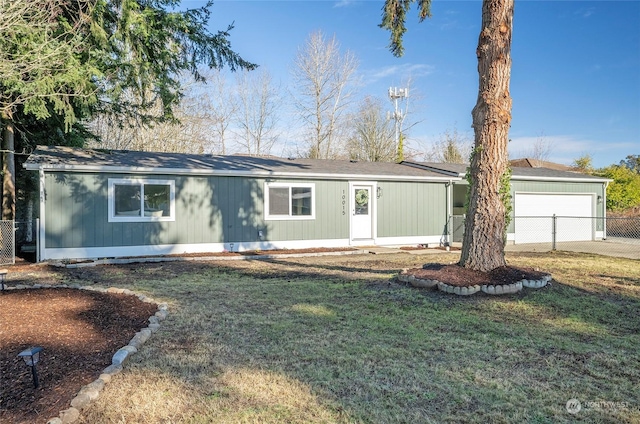 ranch-style house featuring a garage and a front lawn