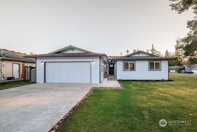 ranch-style house with a garage and a lawn