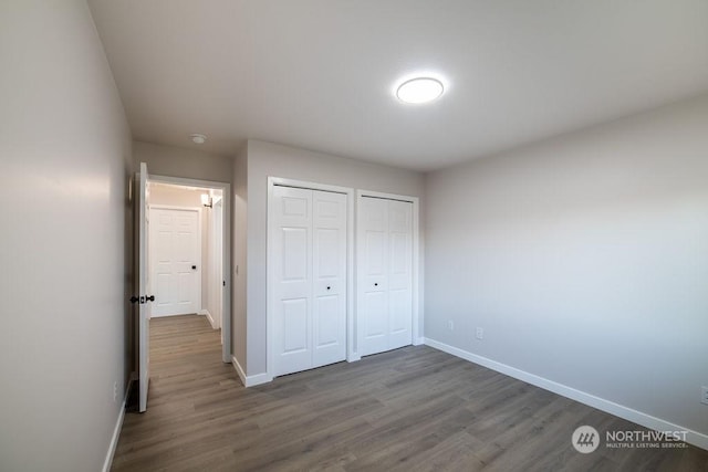 unfurnished bedroom with dark hardwood / wood-style flooring