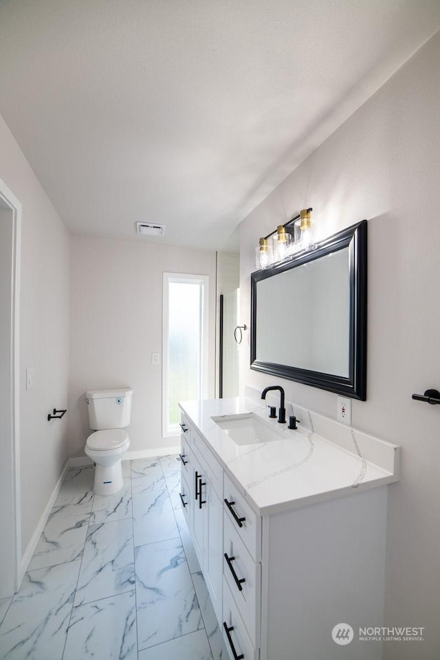 bathroom featuring vanity and toilet