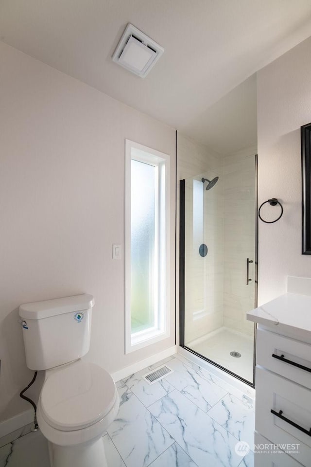 bathroom with vanity, an enclosed shower, and toilet