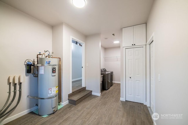 utilities with strapped water heater and washing machine and dryer