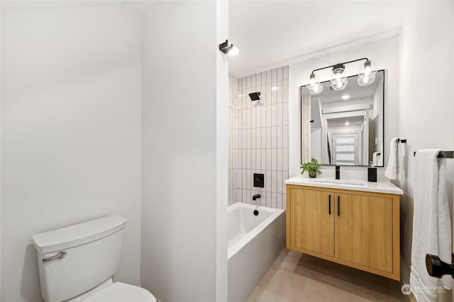 full bathroom with tiled shower / bath, vanity, and toilet