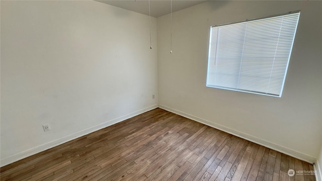 empty room with wood-type flooring