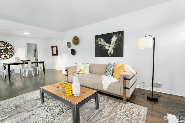 living room featuring dark wood-type flooring