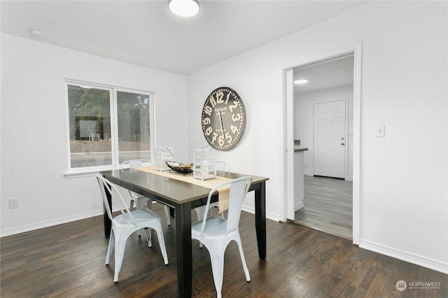 dining room with dark hardwood / wood-style flooring