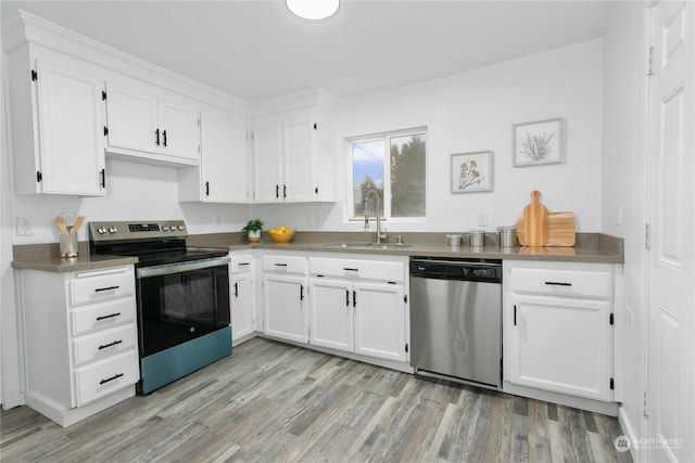 kitchen with sink, stainless steel appliances, light hardwood / wood-style floors, and white cabinets