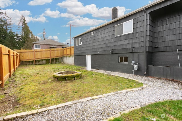 exterior space featuring a yard and an outdoor fire pit