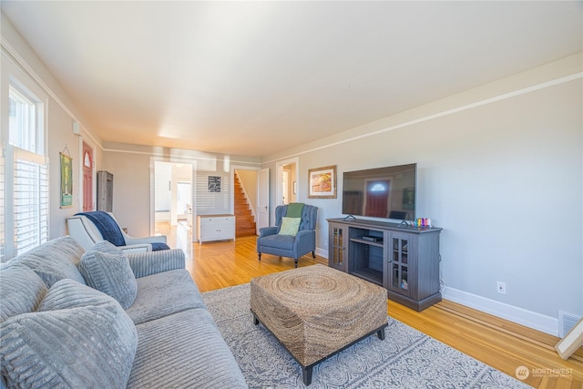 living room with light hardwood / wood-style flooring