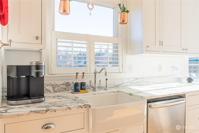 kitchen with white cabinetry, dishwasher, and sink