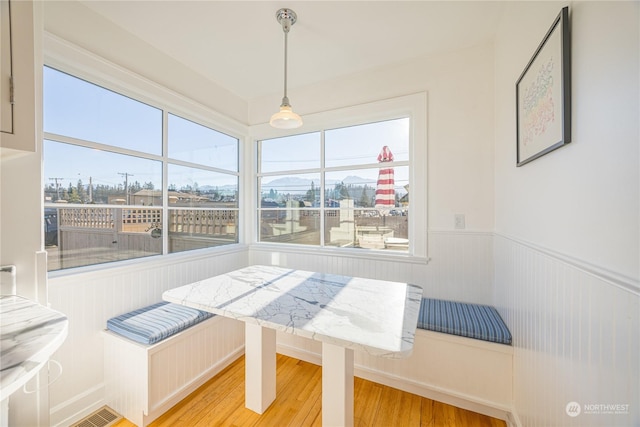 unfurnished dining area featuring hardwood / wood-style flooring, a healthy amount of sunlight, and breakfast area