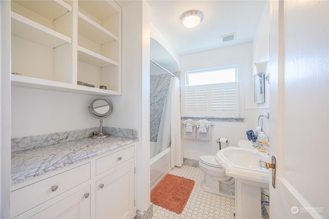 bathroom with shower / bathtub combination with curtain and toilet