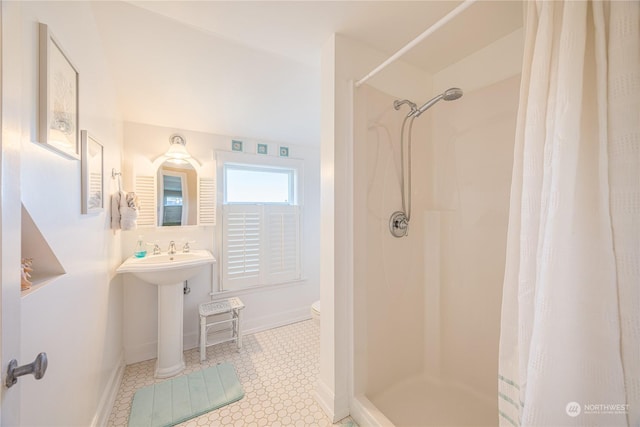 bathroom with tile patterned floors, toilet, and walk in shower