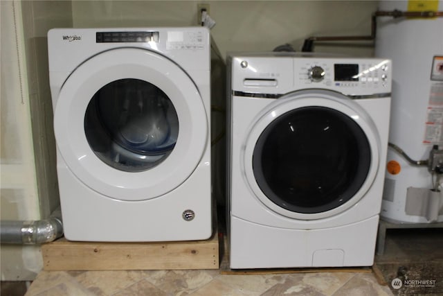 washroom featuring washing machine and clothes dryer and water heater