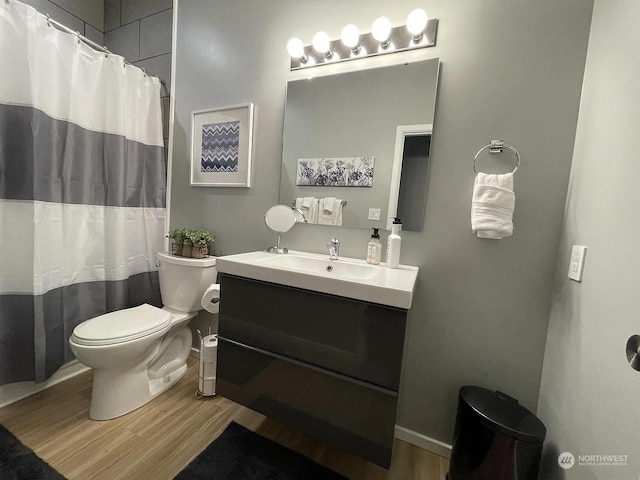 bathroom featuring a shower with shower curtain, vanity, toilet, and hardwood / wood-style floors