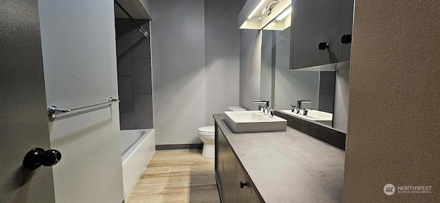 bathroom featuring hardwood / wood-style flooring, vanity, and toilet