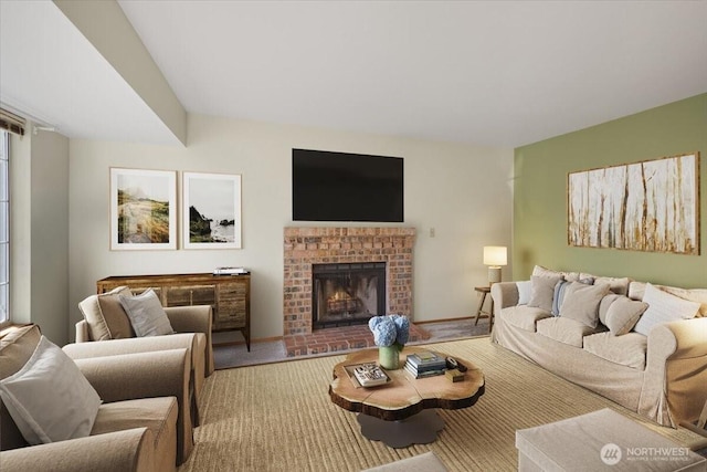 carpeted living room with a brick fireplace