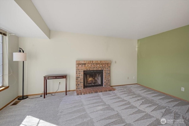 unfurnished living room with light carpet and a fireplace