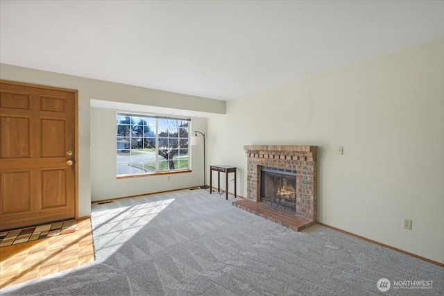 unfurnished living room with light carpet and a brick fireplace