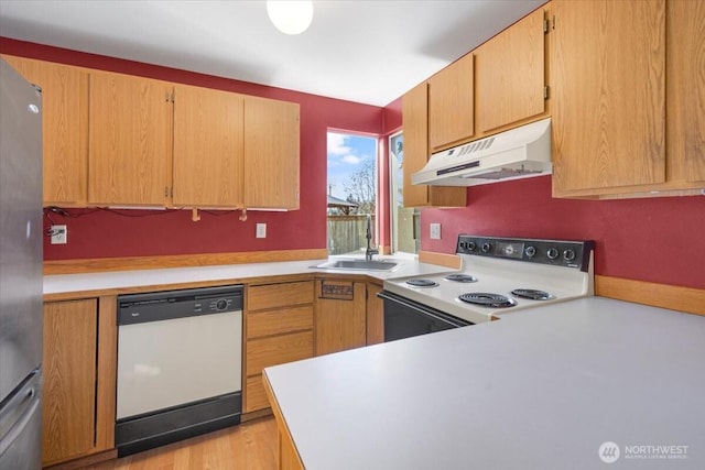 kitchen featuring sink, white appliances, and light hardwood / wood-style floors