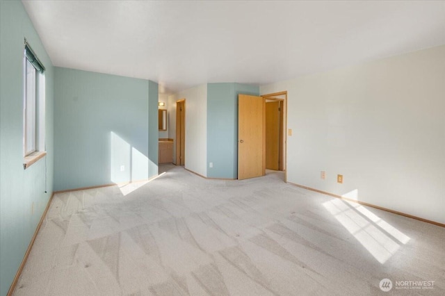 unfurnished room with light colored carpet