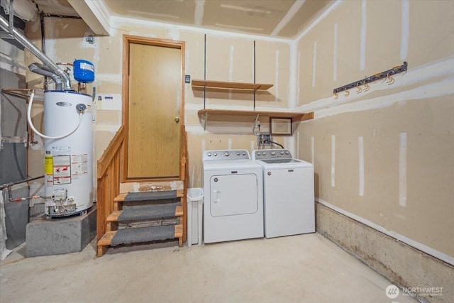 clothes washing area featuring gas water heater and washing machine and dryer