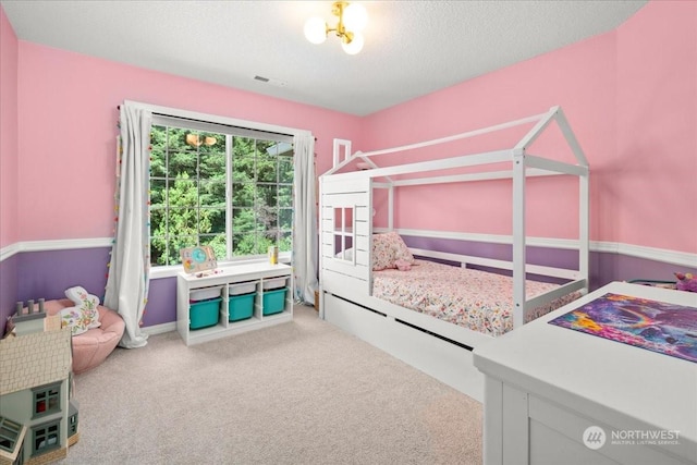 carpeted bedroom with a textured ceiling