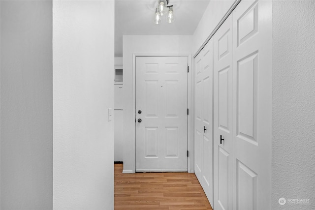 corridor with light hardwood / wood-style floors