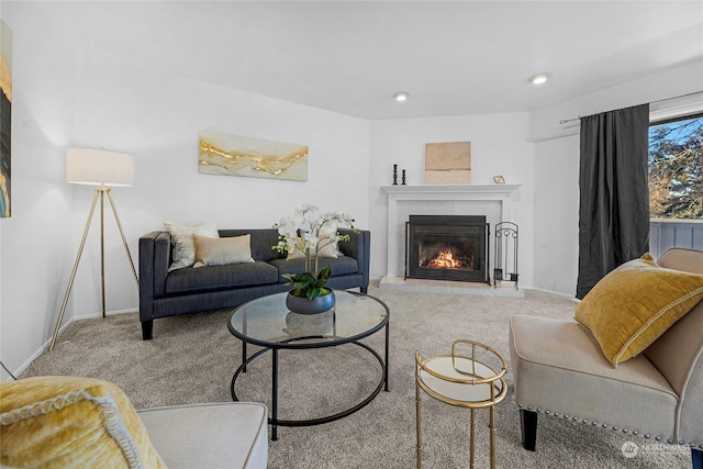 carpeted living room with a tiled fireplace