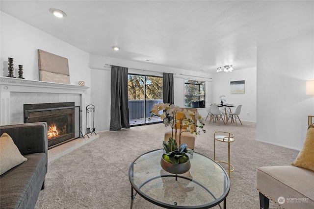 living room with light carpet and a tile fireplace