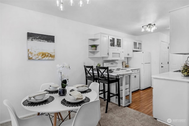 dining room featuring sink and dark hardwood / wood-style flooring