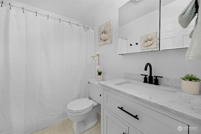 bathroom featuring vanity, tile patterned floors, and toilet