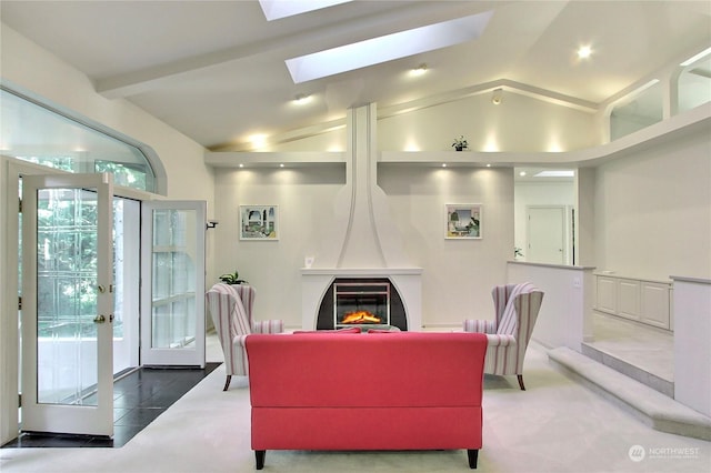 carpeted living room featuring french doors, a fireplace, and lofted ceiling with skylight