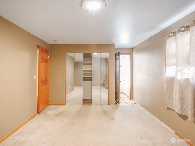 interior space featuring a closet and light carpet