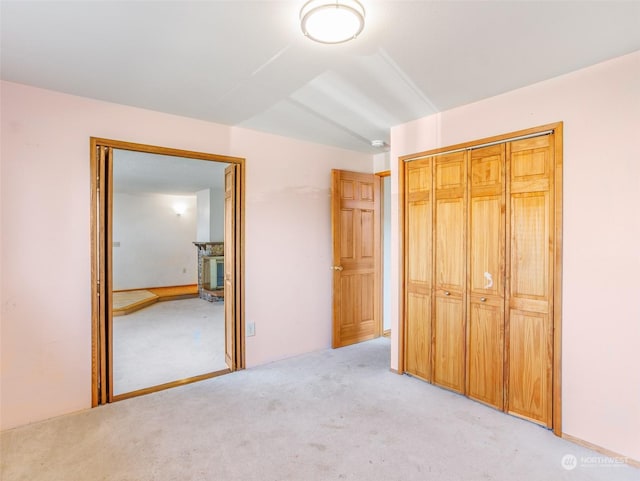 unfurnished bedroom featuring a closet and light carpet