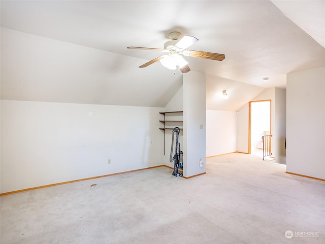 bonus room with ceiling fan, vaulted ceiling, and light carpet