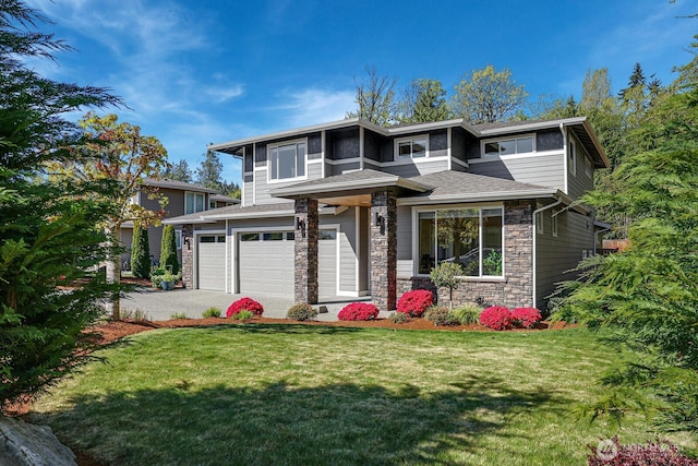 prairie-style home featuring a garage, stone siding, a front lawn, and driveway