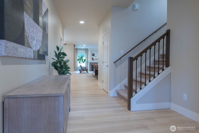 hall featuring recessed lighting, stairway, baseboards, and wood finished floors