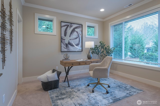 home office with carpet floors, baseboards, visible vents, and ornamental molding