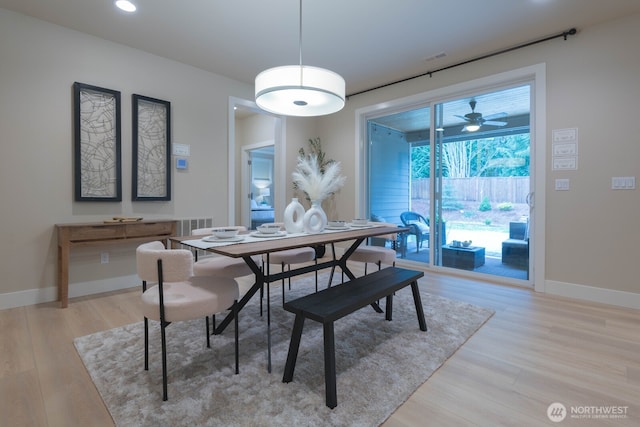 dining area featuring light wood-type flooring and baseboards