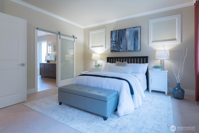 carpeted bedroom featuring ornamental molding, ensuite bath, baseboards, and a barn door