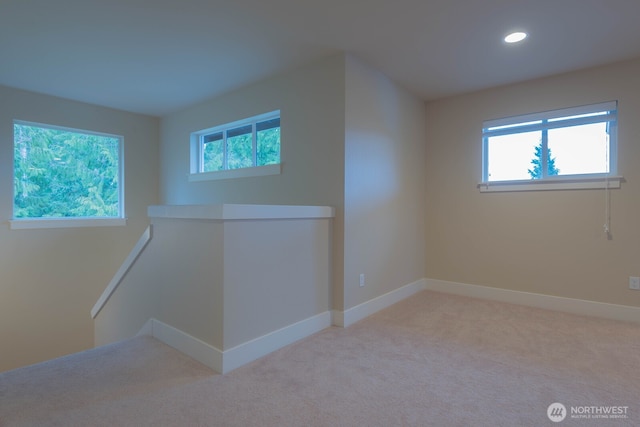 carpeted empty room with plenty of natural light, baseboards, and recessed lighting