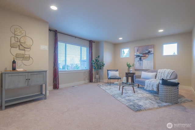 carpeted living room featuring baseboards and recessed lighting