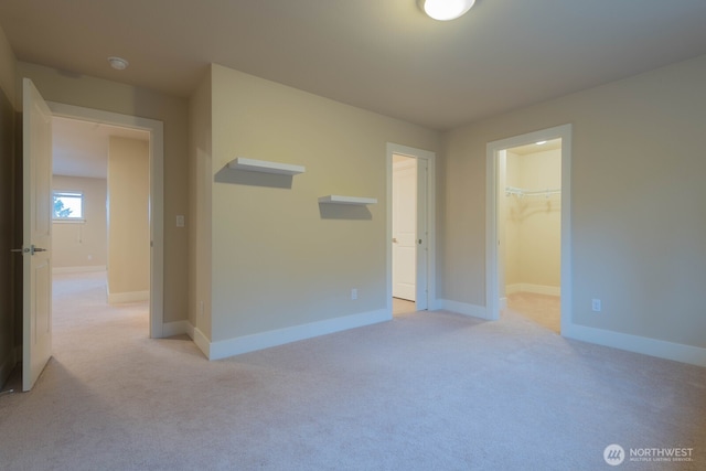 spare room with light carpet and baseboards